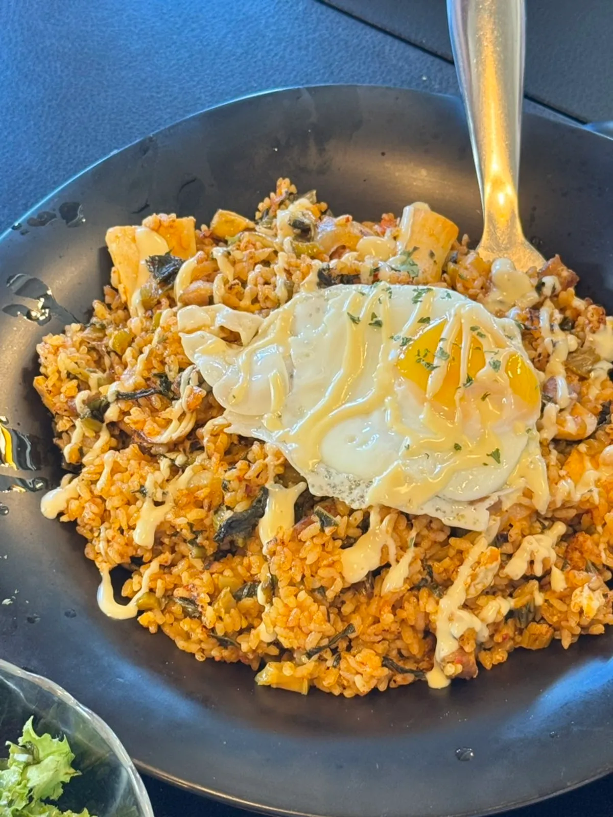 A plate of gat kimchi pilaf with pork neck cubes