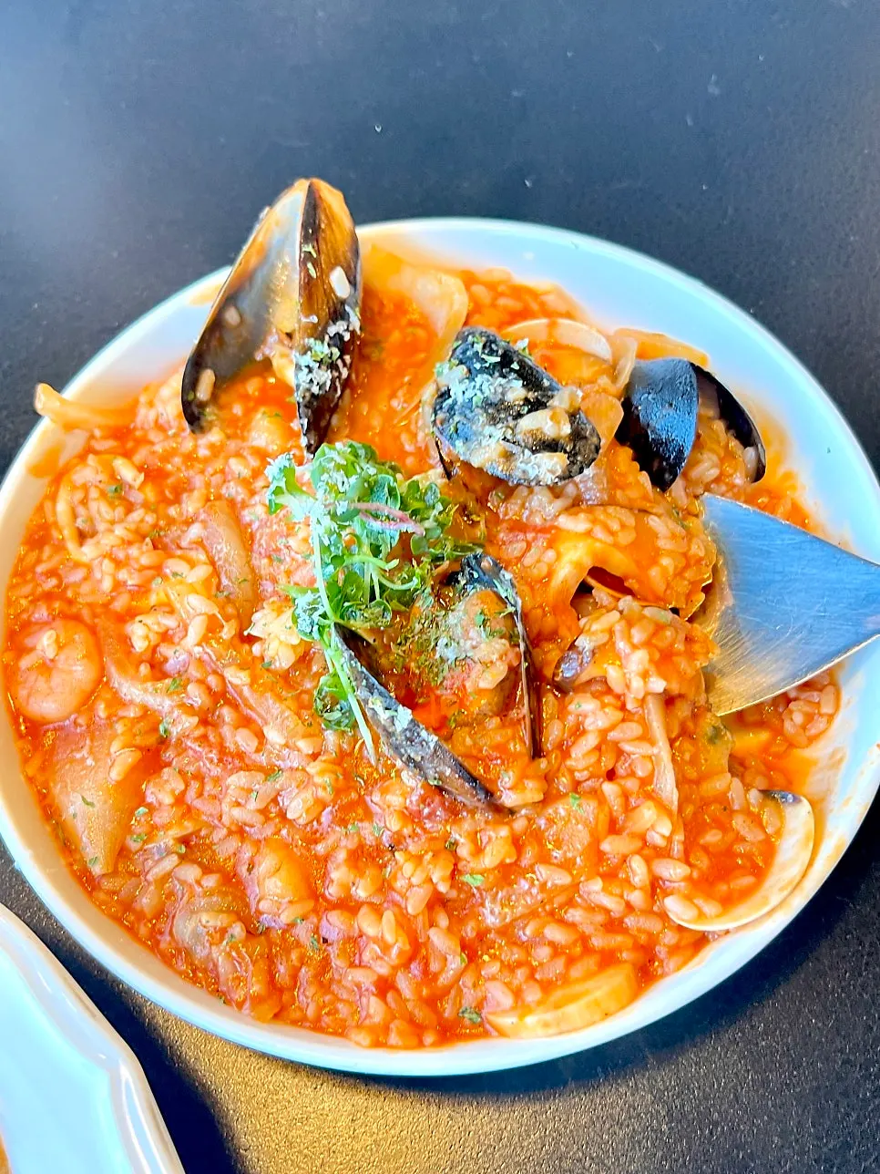 Seafood tomato risotto topped with seafood