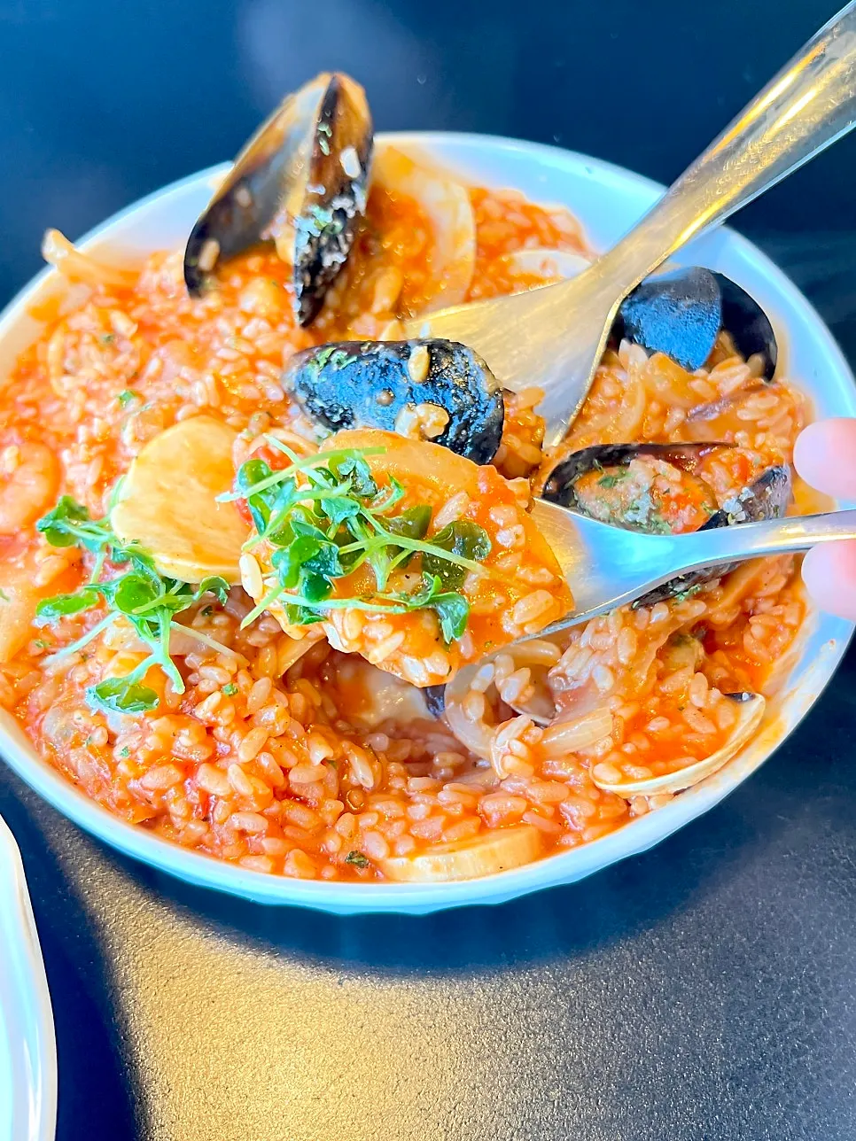 Close-up of seafood tomato risotto piled with toppings
