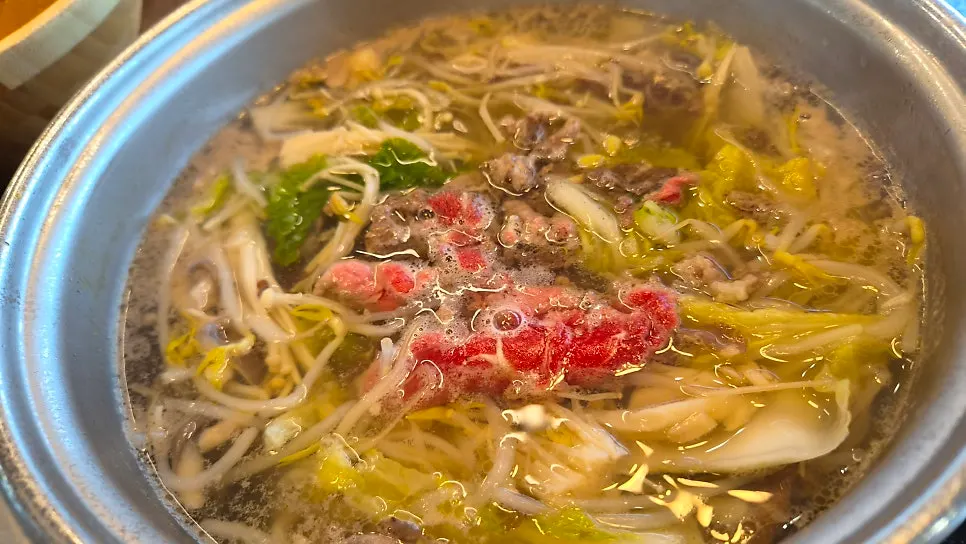 Cooking beef slice by slice in the broth