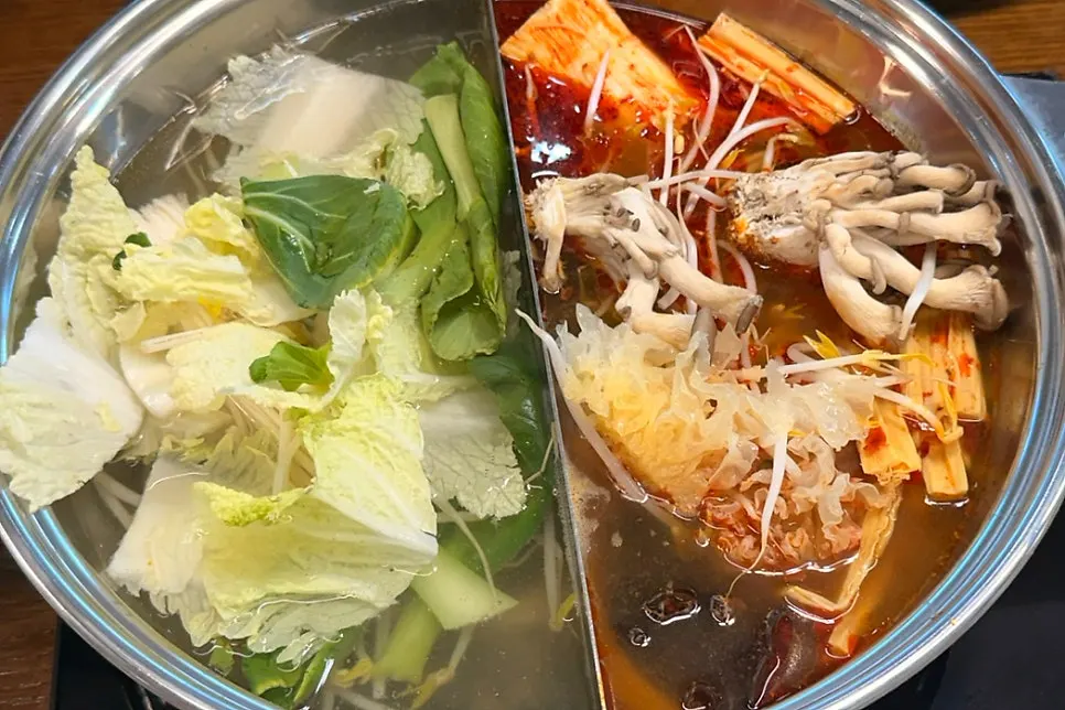 Adding vegetables to the plain broth pot