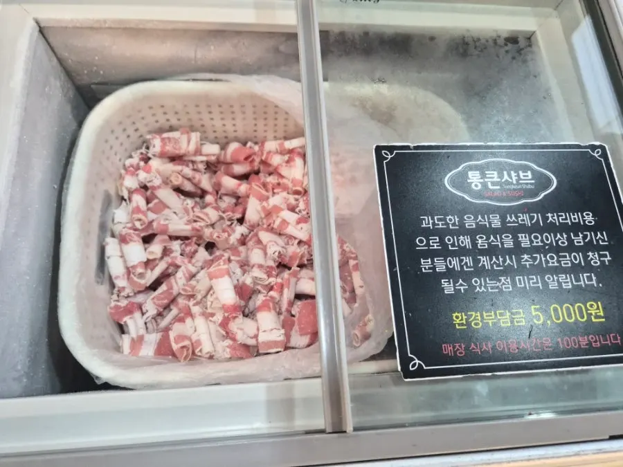 Plate of pork neck and beef brisket for the all-you-can-eat