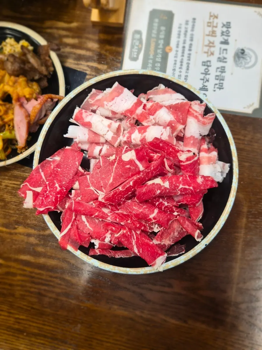 Shabu-shabu being cooked with vegetables and meat