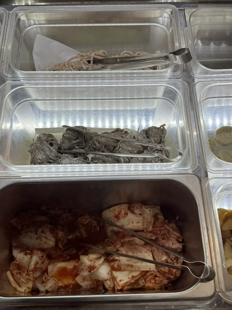 Self-bar corner with kalguksu noodles, dumplings and kimchi