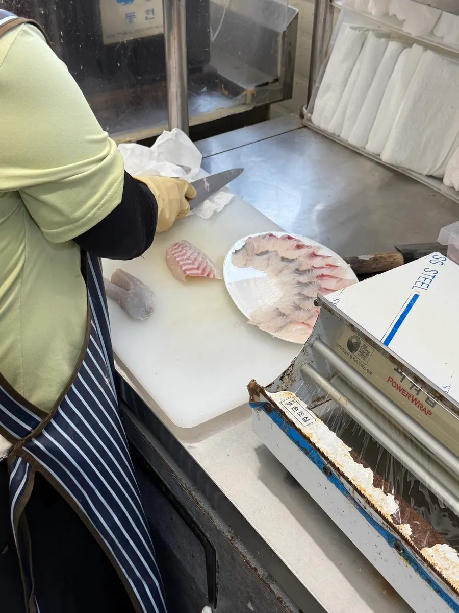Red sea bream and sea bass being prepared after coming out of the tank