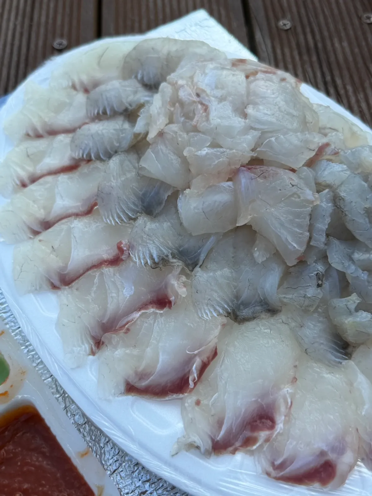 Sashimi spread laid out on a bench in Ungcheon Park