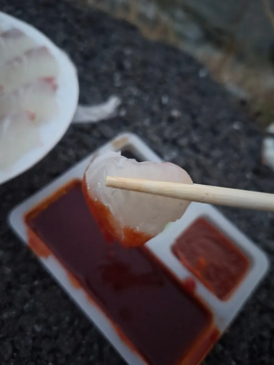 A piece of red sea bream sashimi eaten by the sea