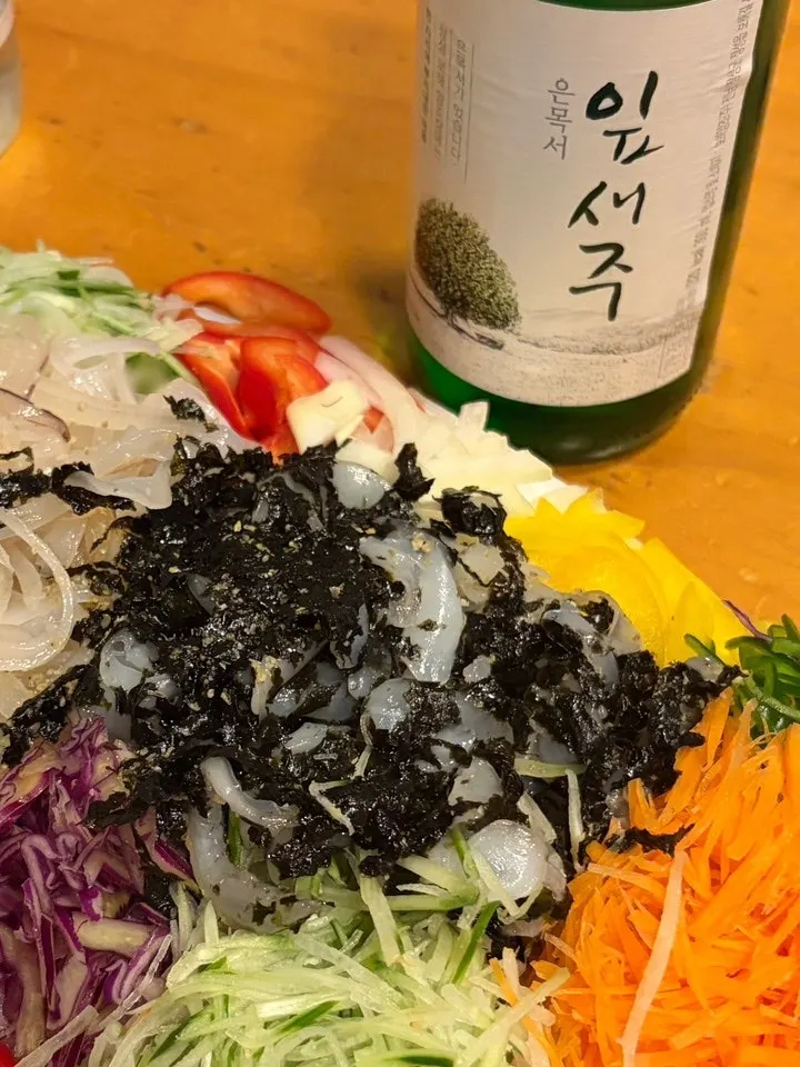 Live squid sashimi spread out as a late-night snack at the lodging