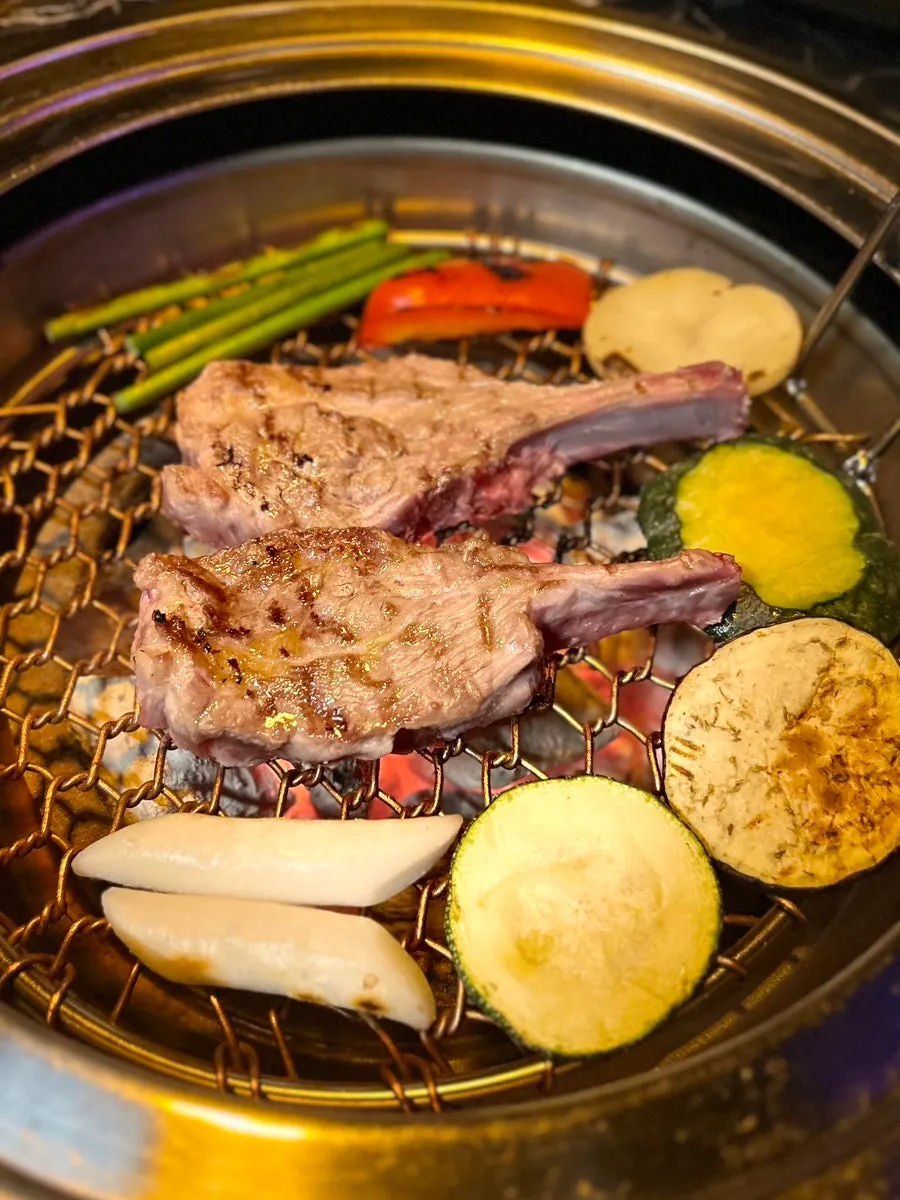 Lamb shoulder rack browning on the grill