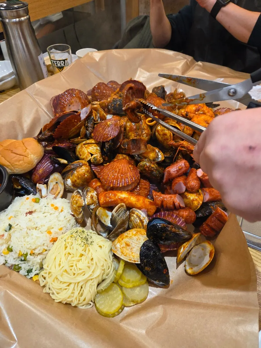 Seafood boil mixing clams, squid, abalone, and shrimp