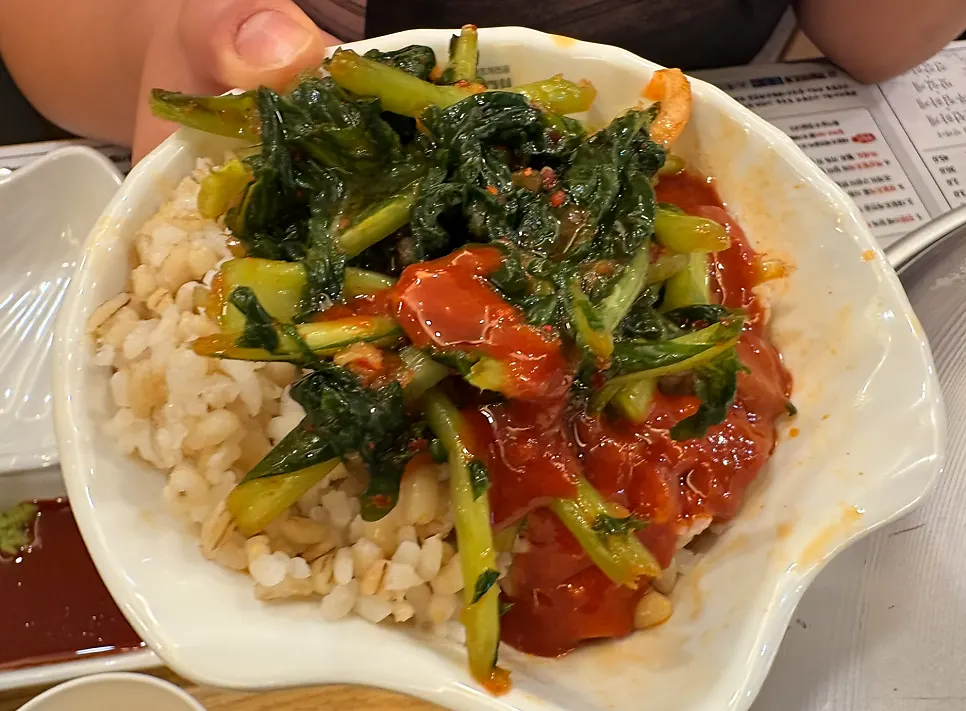A spoonful of barley rice mixed with gochujang sauce