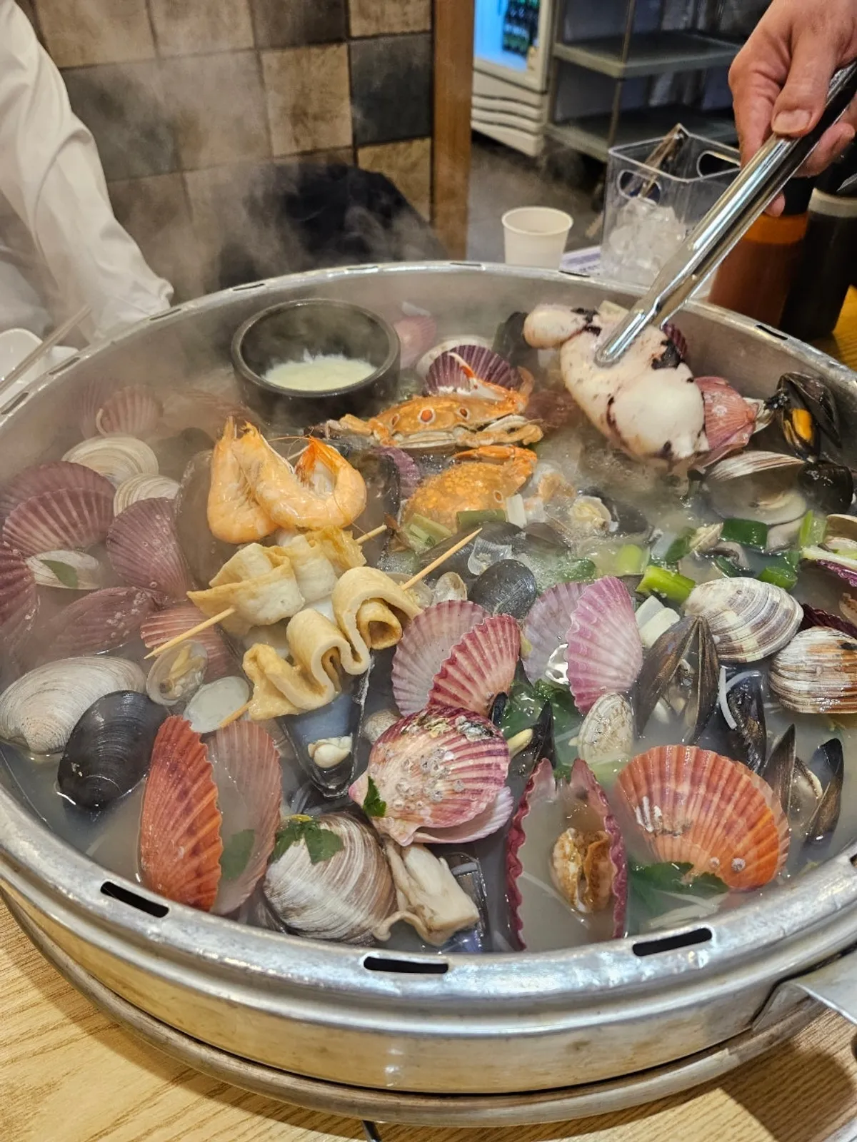 Pot of giant clam hot pot loaded with seafood