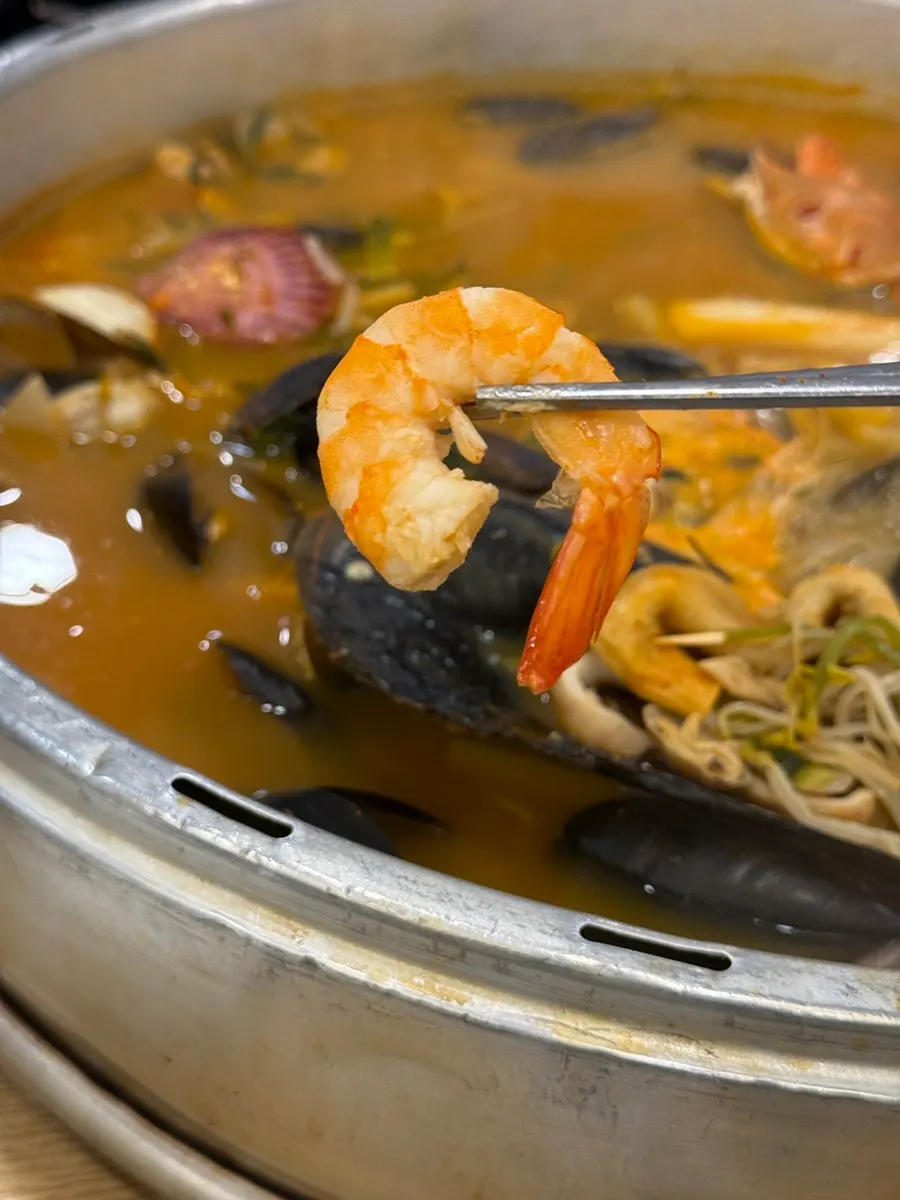 Generous table spread of clam hot pot