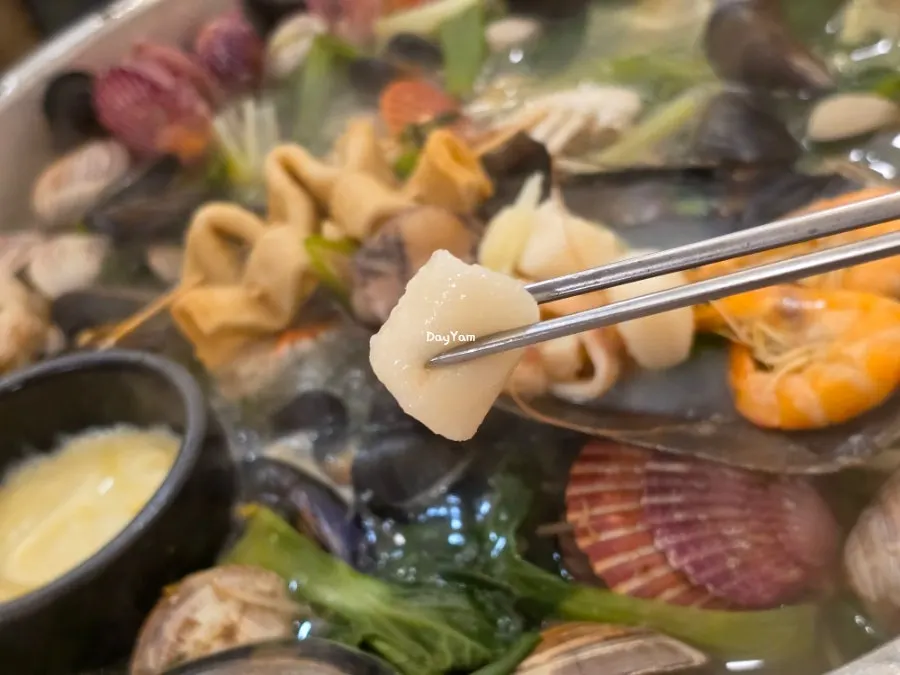 Clam broth scooped into a small side dish