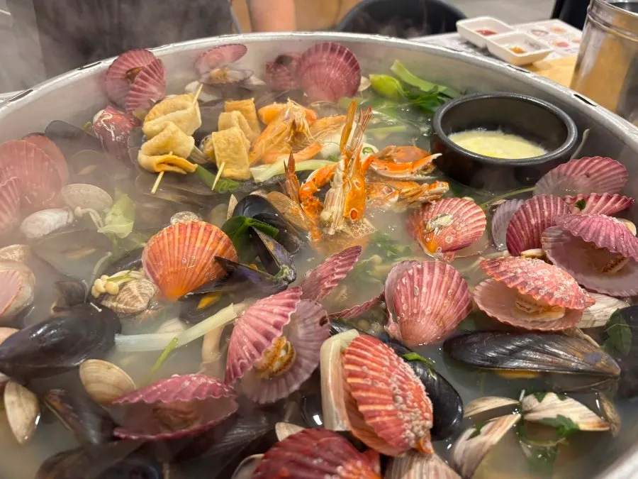 Hot pot seafood including red scallops and blue crab