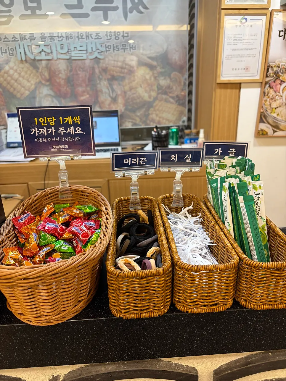 Candy, hair ties, floss and mouthwash set out at the entrance