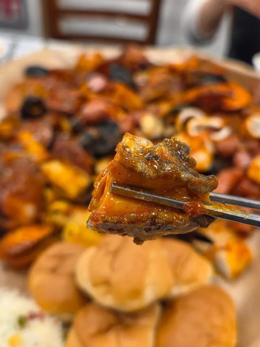 Close-up of sauce-coated clams and seafood