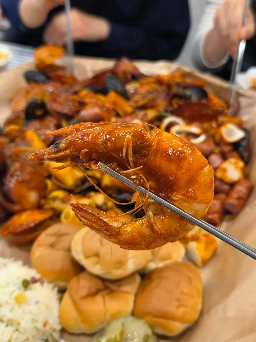 Table of people sharing the seafood boiling together