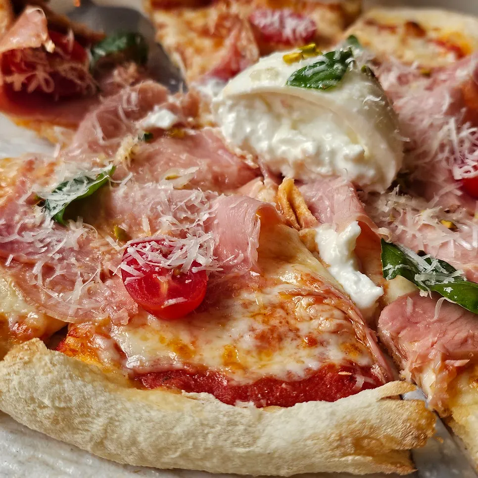 Salumi pizza with prosciutto ham and basil
