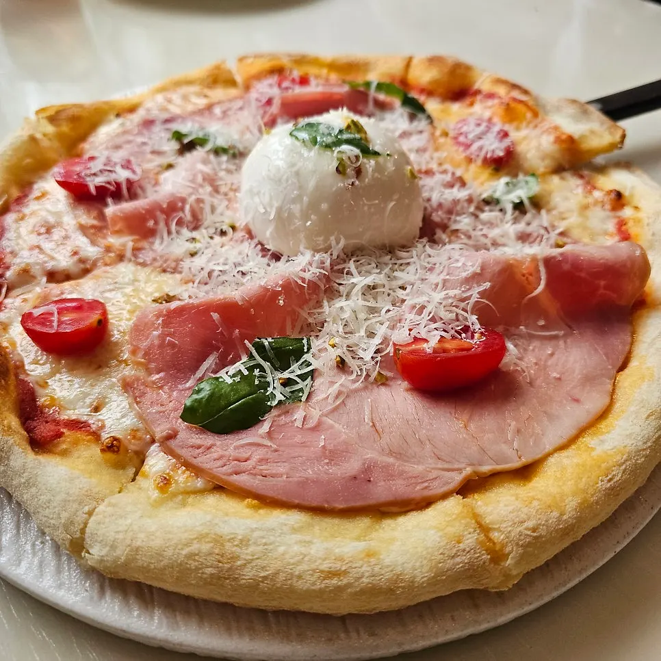 A single slice pulled from the salumi pizza