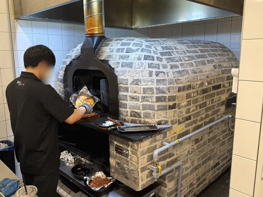 Large wood-fired oven at the back of the restaurant