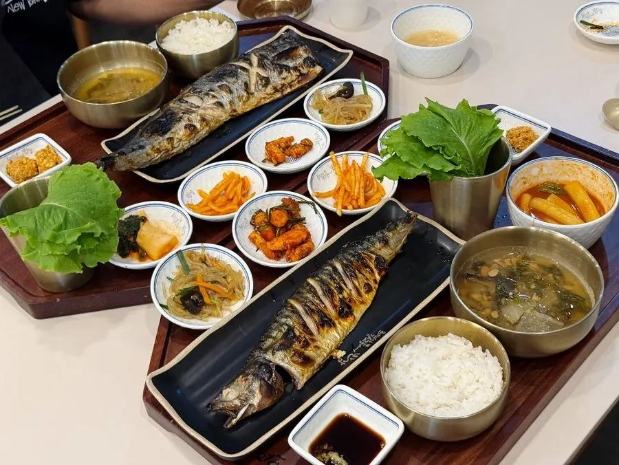 Two table settings with the grilled mackerel set and the grilled mackerel pike set