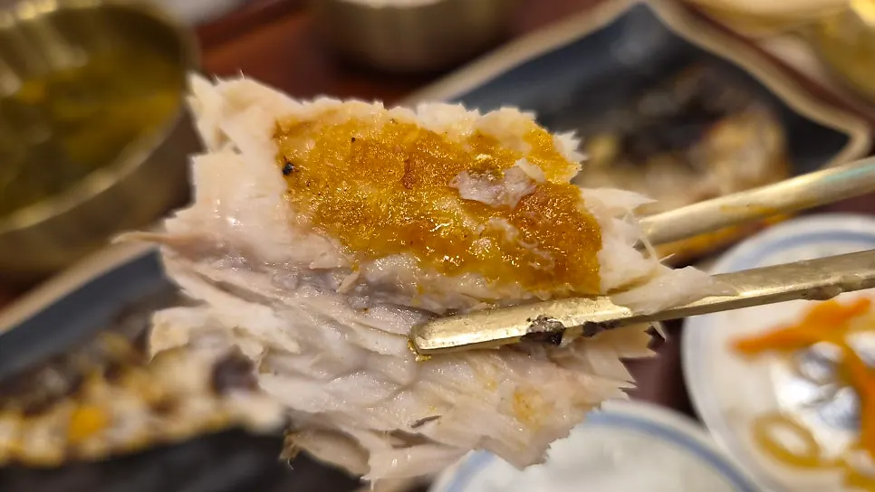 A piece of fish placed on top of rice