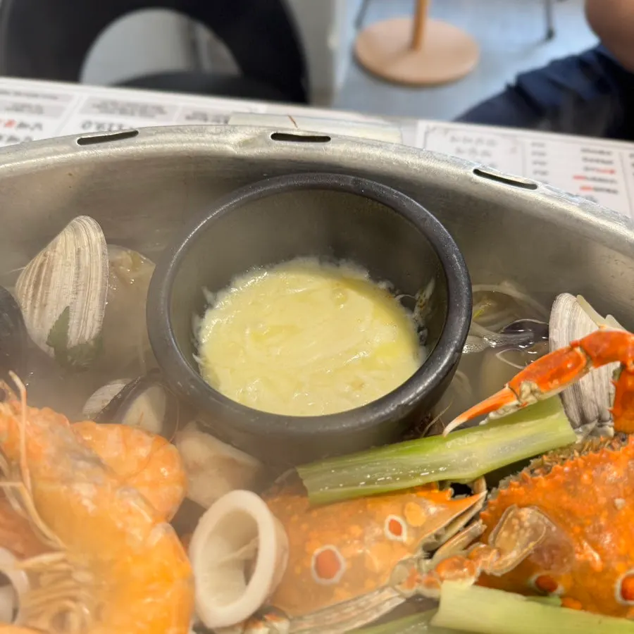 Plate of seafood pulled out of the hot pot