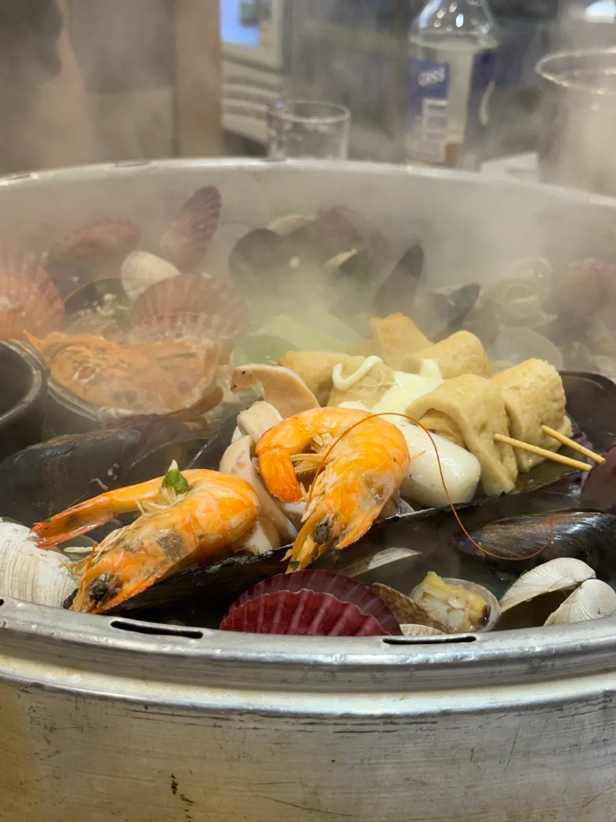 Pot of giant clam hot pot packed with seafood