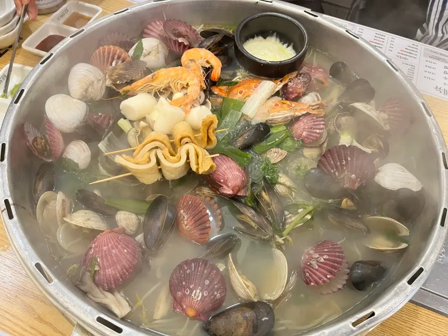 Seafood inside the king clam hot pot after the lid opens