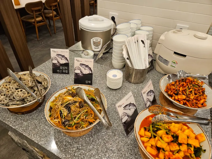 Self-serve salad bar with side dishes and rice