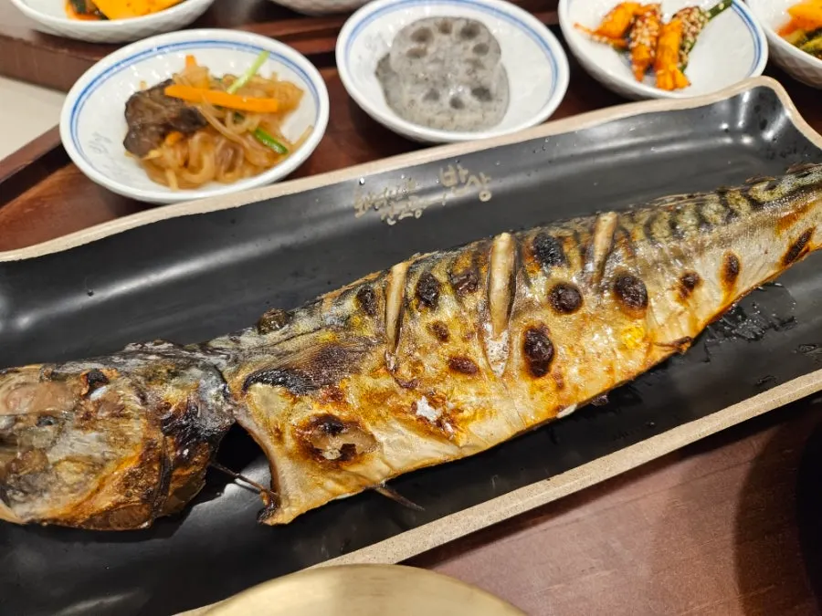 Golden-brown wood-fired grilled mackerel