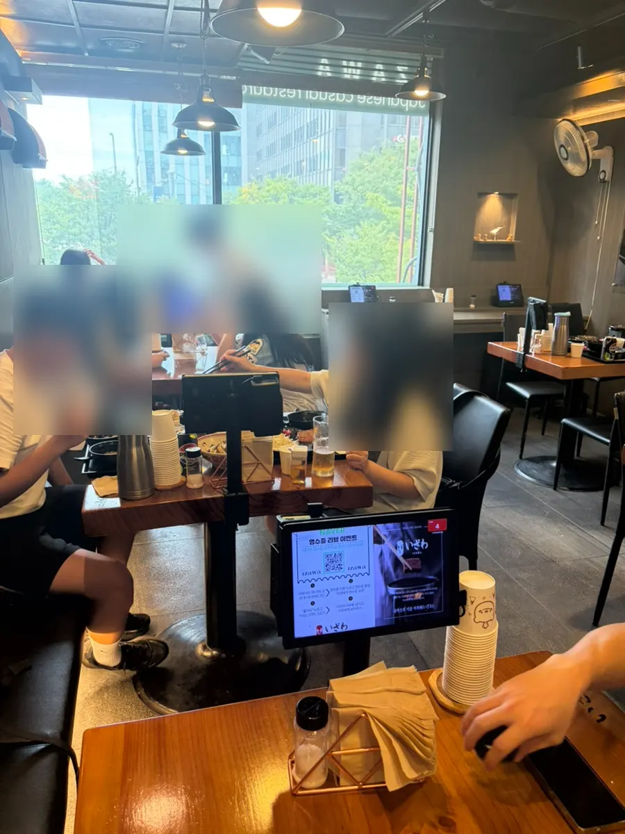Table seating with large windows inside Izawa Yeouido Direct Store