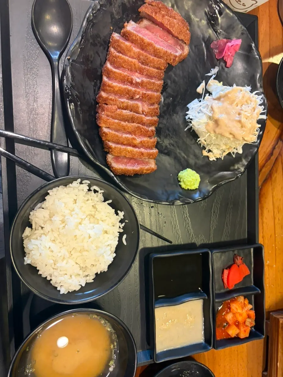 A piece of gyukatsu grilling on both sides
