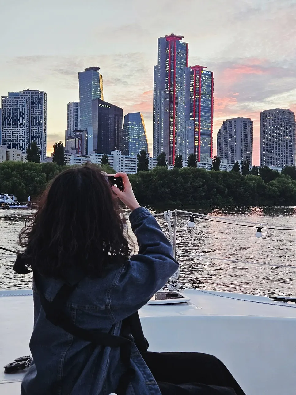 Yacht deck against a sunset-lit Han River backdrop