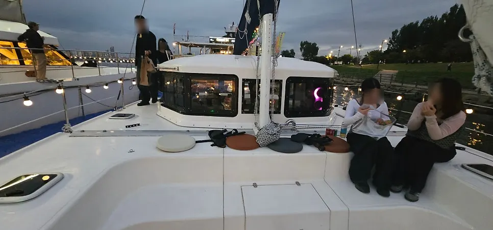 The yacht deck with everyone wearing life jackets