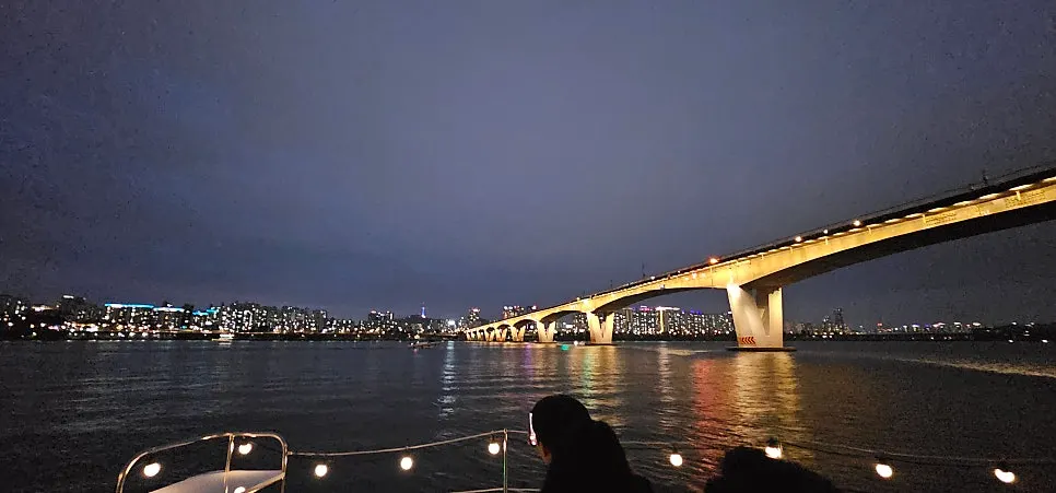 Buildings around the Han River as their lights start turning on
