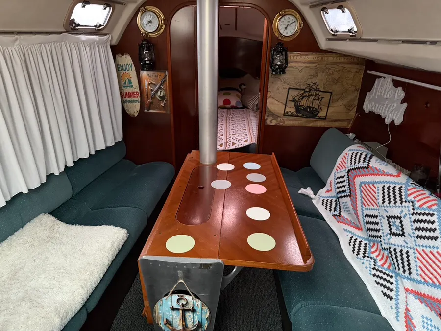 Below-deck yacht space with a table and bed