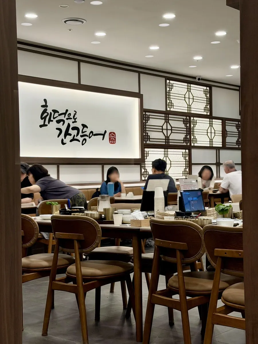 Restaurant interior in ivory and wood tones
