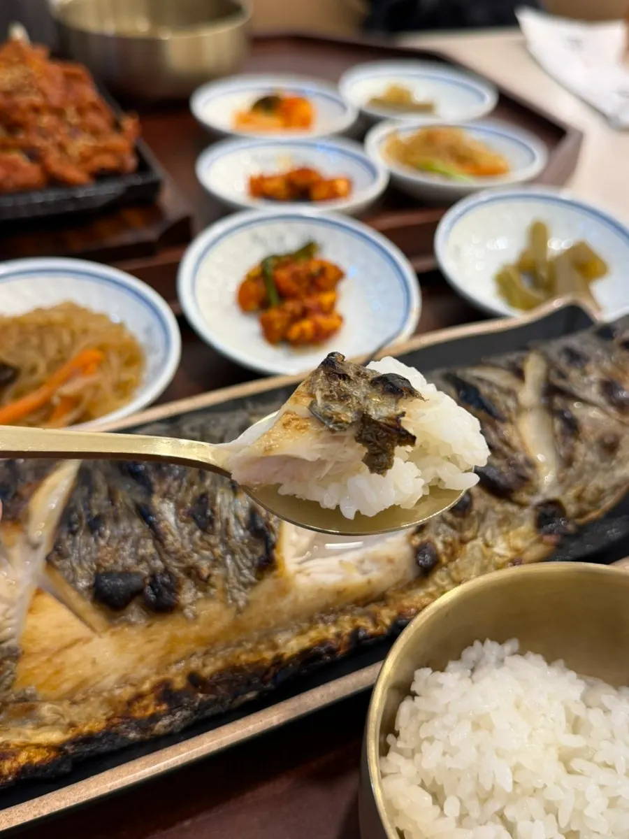 Sauce-coated jeyuk pork piled on a spoonful of rice