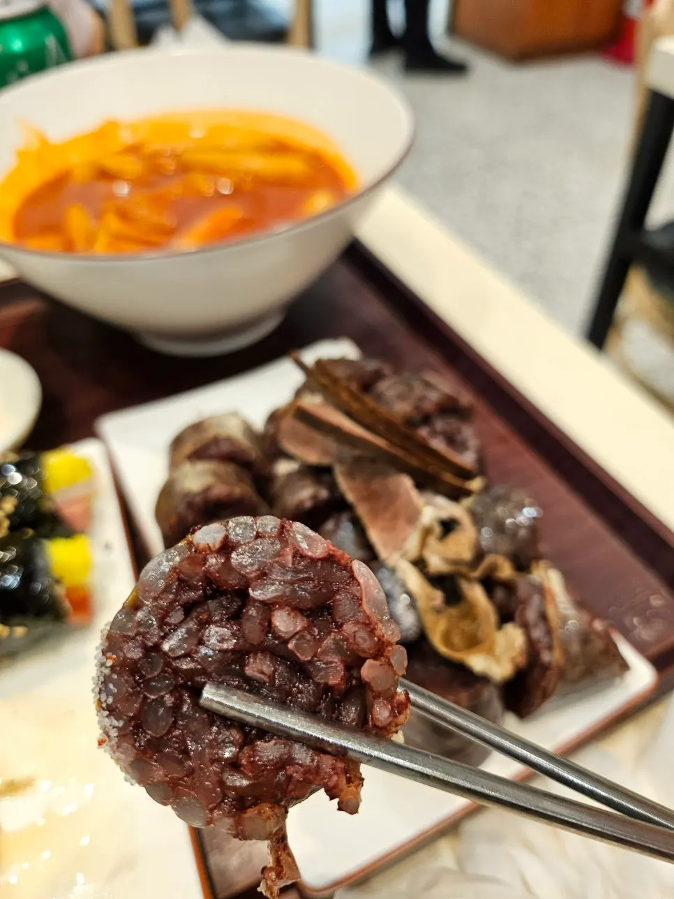 Sundae and fried snacks dipped into tteokbokki sauce