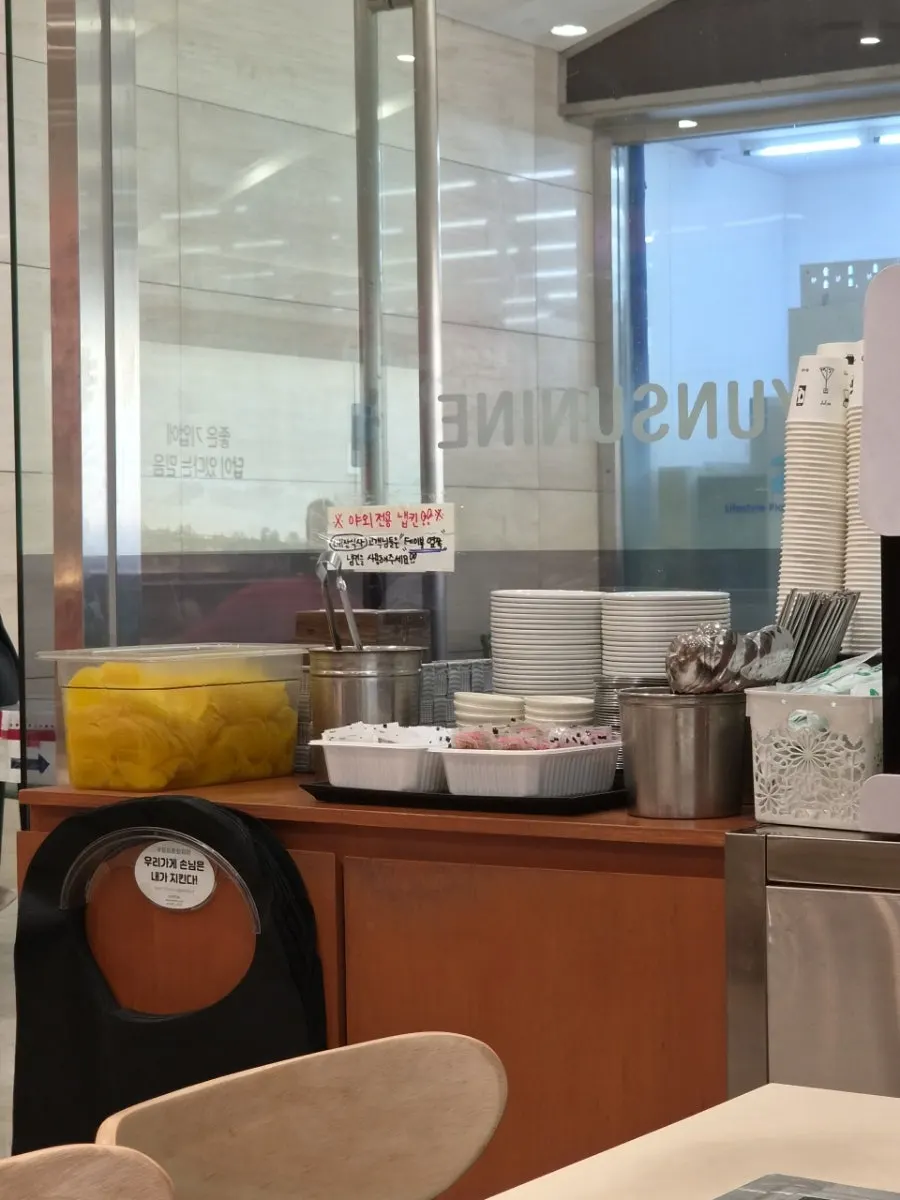Self-serve bar with pickled radish, utensils, and cups