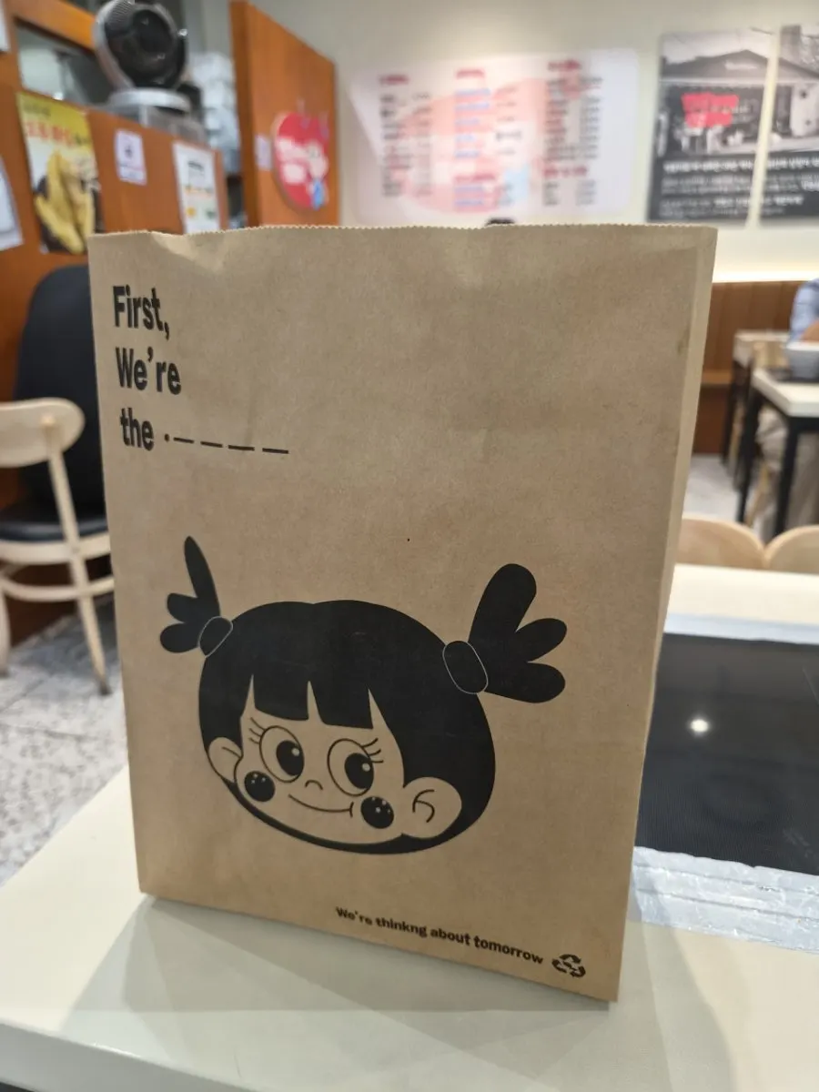 Paper takeout bag with a character illustration