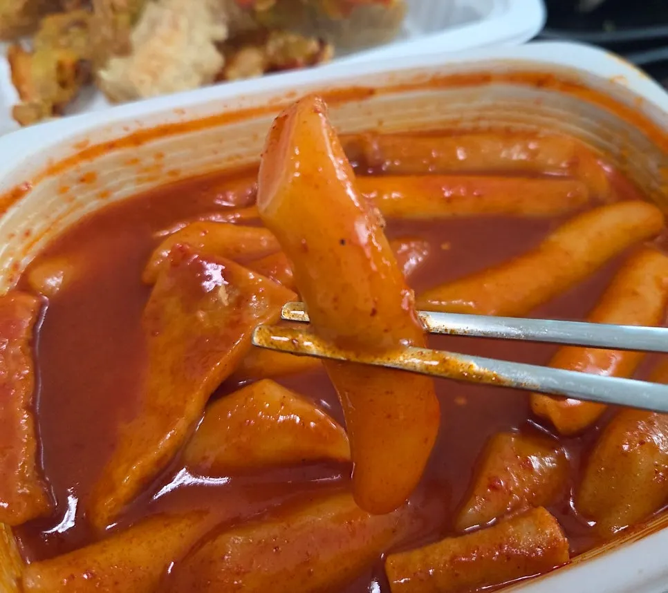 Full spread of tteokbokki, sundae, fried snacks, and mini gimbap