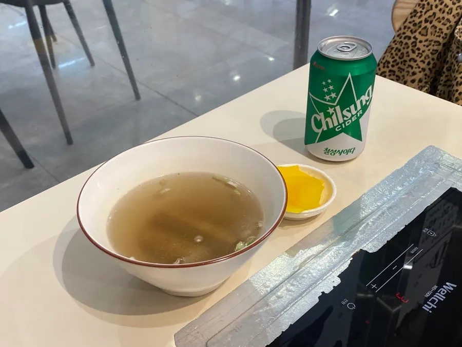 Fish cake broth and cider ordered alongside the tteokbokki
