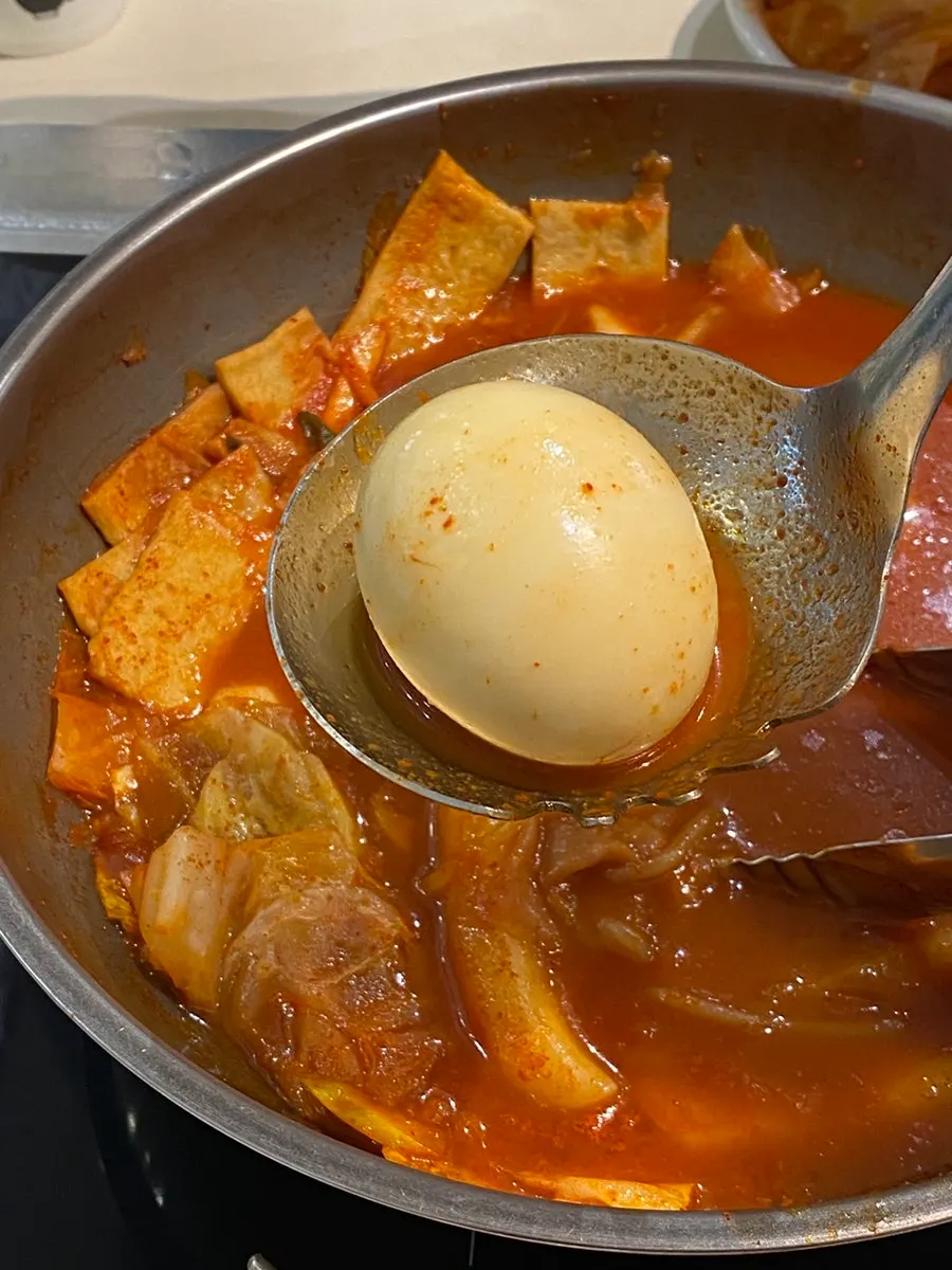 Egg broken and stirred into the sauce