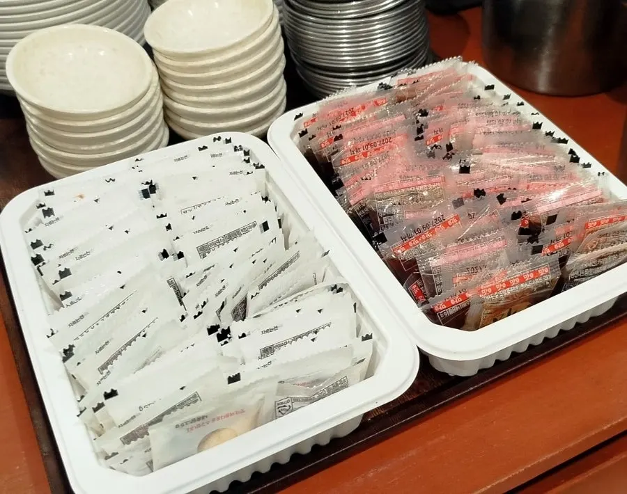 Self-serve corner with radish pickles and utensils