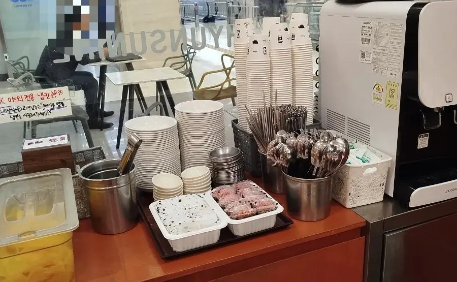 Spoons and chopsticks laid out at the self-serve corner