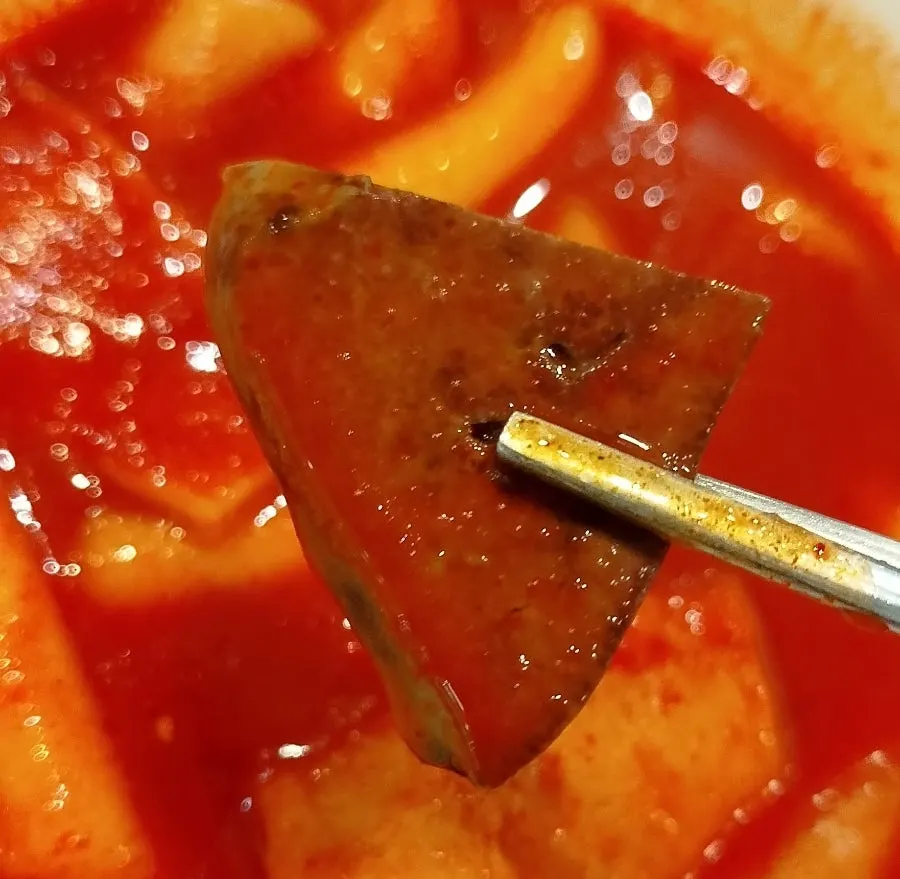 Sundae dipped in tteokbokki sauce