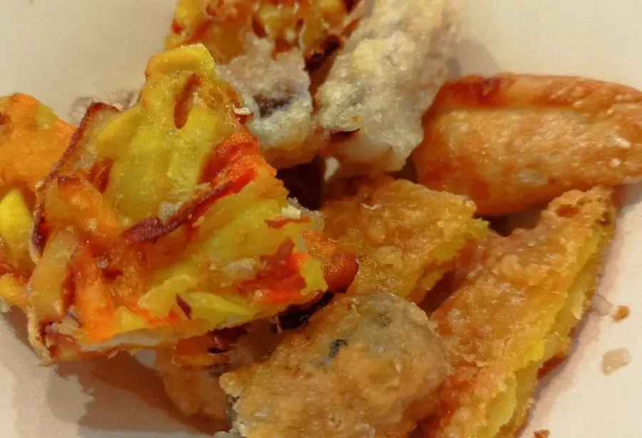 Fried snack dipped in tteokbokki sauce